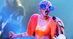 Miley Cyrus wearing glasses on stage 