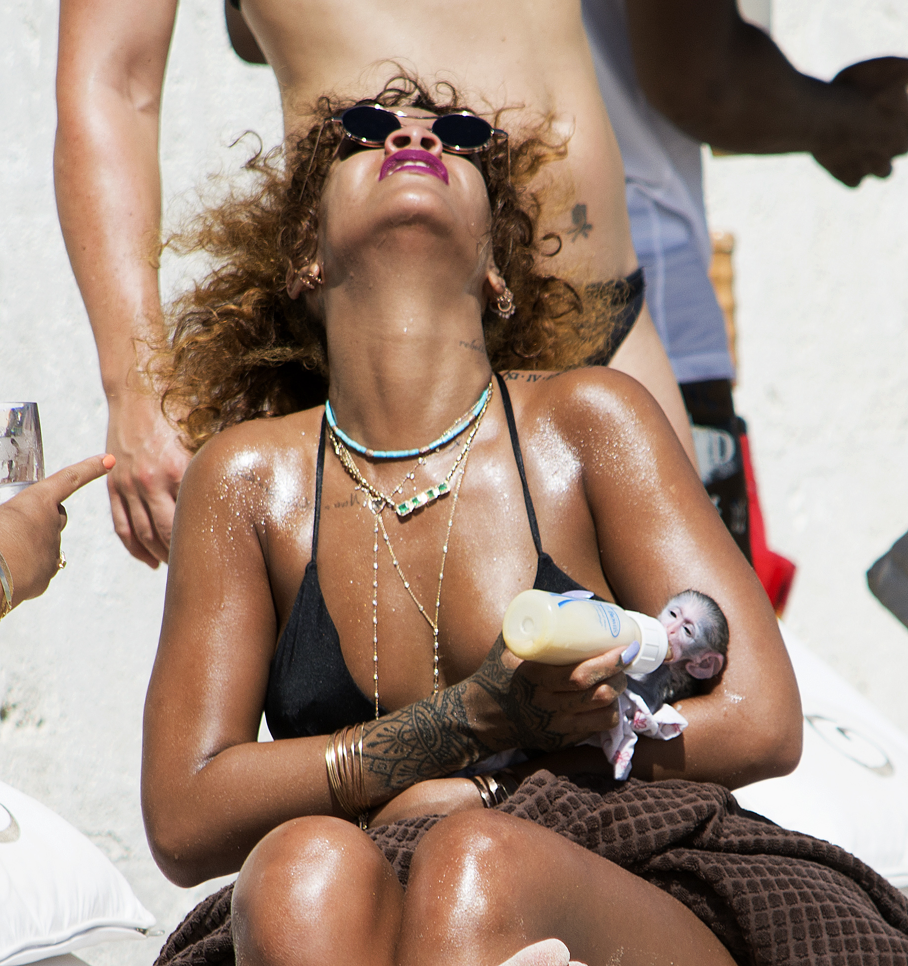 Rihanna bottle feeds a monkey on holiday