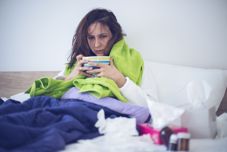 A woman sick in bed stock photo 