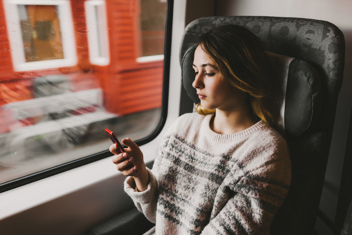 Woman looking at her phone on the train 