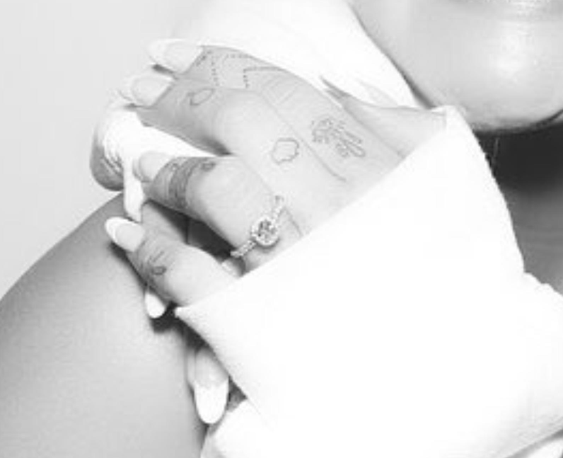 Ariana Grande dot arrow tattoo left finger