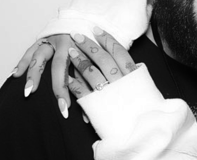 Ariana Grande symbol tattoo left ring finger